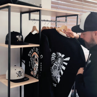 Butchers & Barons - Maarten showing a t-shirt from the collection